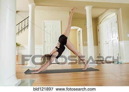 Caucasian woman practicing yoga in home View Large Photo Image Stock Photo - Caucasian woman practicing yoga in home. Fotosearch