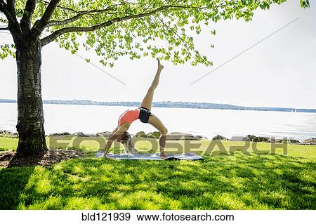 Caucasian woman practicing yoga outdoors View Large Photo Image Stock Photo - Caucasian woman practicing yoga outdoors. Fotosearch