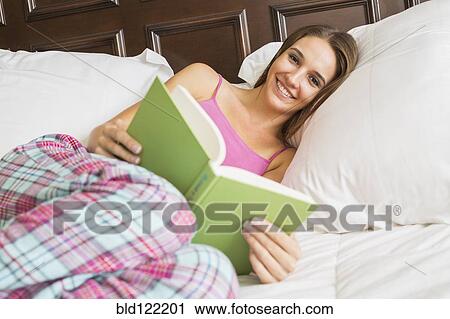 Caucasian woman reading in bed View Large Photo Image Stock Image - Caucasian woman reading in bed. Fotosearch