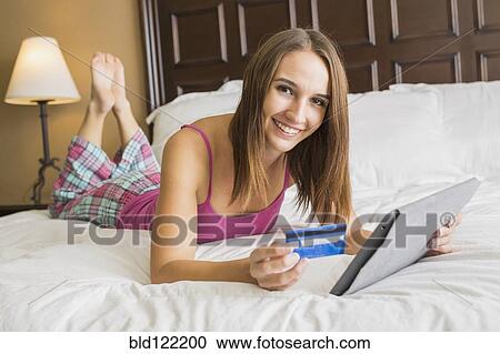Caucasian woman shopping online with digital tablet View Large Photo Image Stock Image - Caucasian woman shopping online with digital tablet. Fotosearch