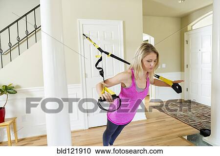 Caucasian woman using resistance band equipment in home View Large Photo Image Stock Image - Caucasian woman using resistance band equipment in home. Fotosearch
