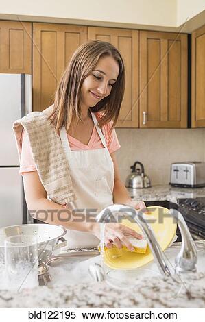 Caucasian woman washing dishes in kitchen View Large Photo Image Stock Photography - Caucasian woman washing dishes in kitchen. Fotosearch