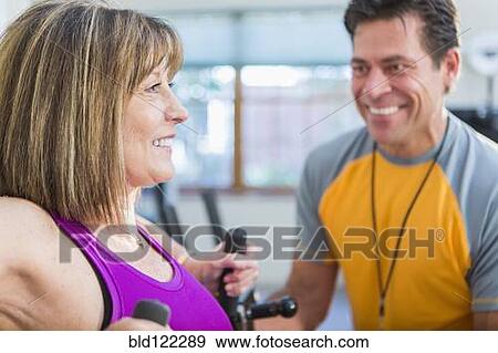 Caucasian woman working with personal trainer in gym View Large Photo Image Stock Photo - Caucasian woman working with personal trainer in gym. Fotosearch