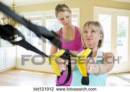 Caucasian woman working with trainer in home View Large Photo Image Stock Image - Caucasian woman working with trainer in home. Fotosearch
