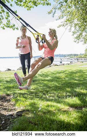 Picture - Caucasian woman working with trainer outdoors. Fotosearch