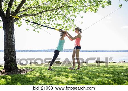 Caucasian woman working with trainer outdoors View Large Photo Image Stock Image - Caucasian woman working with trainer outdoors. Fotosearch