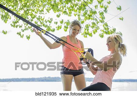 Caucasian woman working with trainer outdoors View Large Photo Image Stock Photography - Caucasian woman working with trainer outdoors. Fotosearch