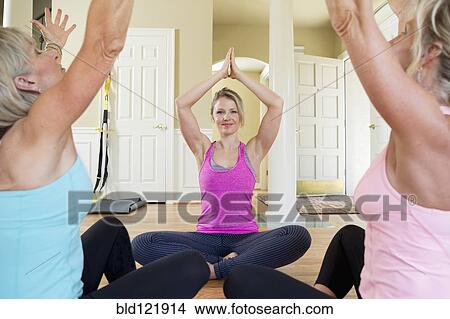 Caucasian women practicing yoga in home View Large Photo Image Picture - Caucasian women practicing yoga in home. Fotosearch