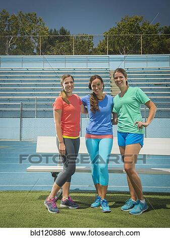 Stock Photograph - Caucasian women smiling in stadium. Fotosearch
