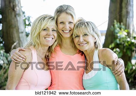 Caucasian women smiling outdoors View Large Photo Image Stock Image - Caucasian women smiling outdoors. Fotosearch