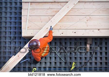Stock Photo - Caucasian worker at construction site. Fotosearch