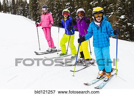 Stock Photo - Children skiing together on snowy slope. Fotosearch