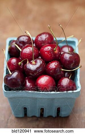 Stock Image - Close up of bing cherries in carton. Fotosearch
