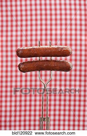 Stock Image - Close up of hot dogs on poker. Fotosearch