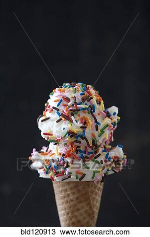 Close up of ice cream cone with sprinkles View Large Photo Image Stock Image - Close up of ice cream cone with sprinkles. Fotosearch