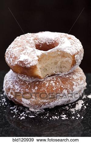Stock Photo - Close up of powdered donuts. Fotosearch