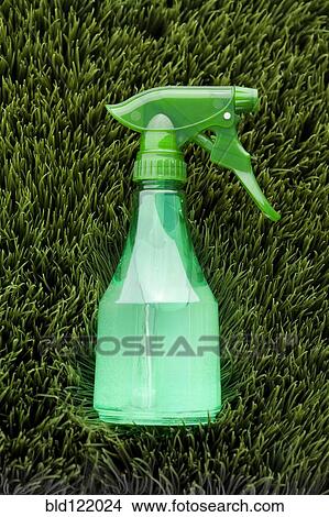 Picture - Close up of spray bottle in grass. Fotosearch