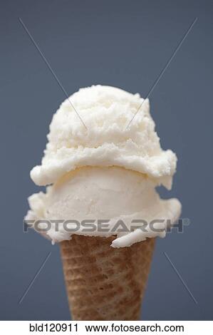 Stock Image - Close up of vanilla ice cream cone. Fotosearch