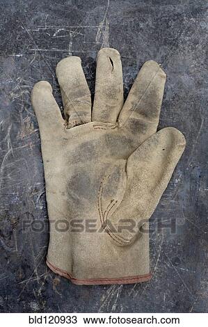 Stock Image - Close up of worn work glove. Fotosearch