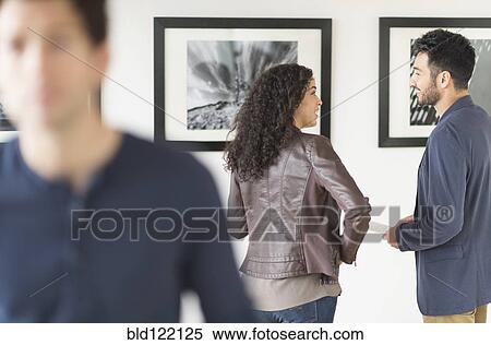 Couple admiring art in gallery View Large Photo Image Stock Photography - Couple admiring art in gallery. Fotosearch