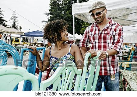 Couple buying colorful chairs at flea market View Large Photo Image Stock Image - Couple buying colorful chairs at flea market. Fotosearch