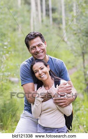 Couple hugging in forest View Large Photo Image Stock Photo - Couple hugging in forest. Fotosearch