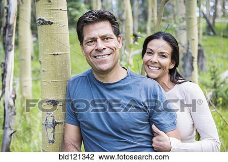 Couple smiling in forest View Large Photo Image Stock Image - Couple smiling in forest. Fotosearch
