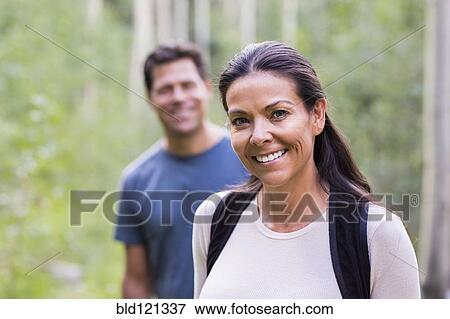 Stock Photo - Couple smiling in forest. Fotosearch
