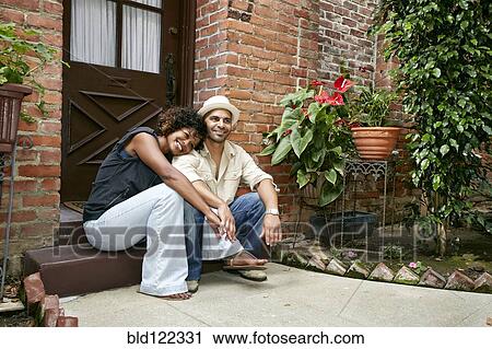 Couple smiling together on front stoop View Large Photo Image Stock Image - Couple smiling together on front stoop. Fotosearch
