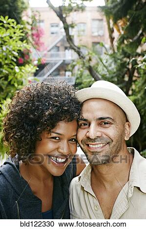 Stock Image - Couple smiling together outdoors. Fotosearch