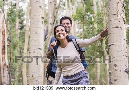 Couple walking together in forest View Large Photo Image Stock Photo - Couple walking together in forest. Fotosearch