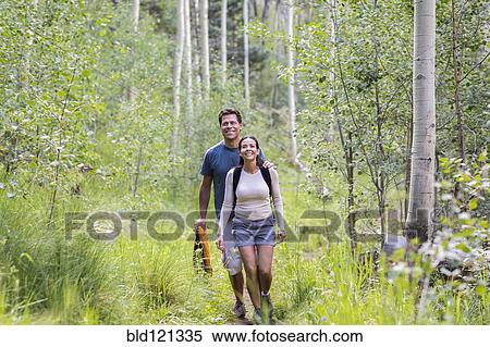 Stock Photography - Couple walking together in forest. Fotosearch