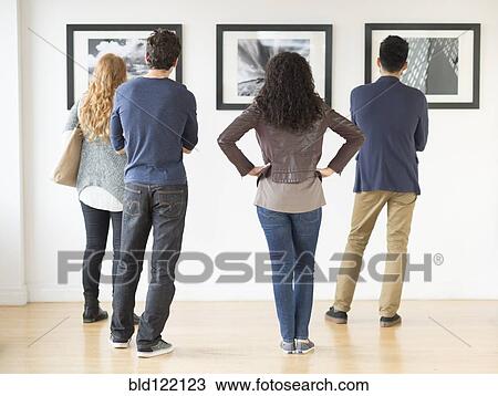 Couples admiring art in gallery View Large Photo Image Stock Image - Couples admiring art in gallery. Fotosearch