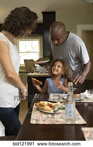 Family eating together at table View Large Photo Image Stock Image - Family eating together at table. Fotosearch
