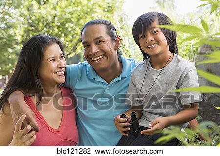 Stock Image - Family smiling outdoors. Fotosearch