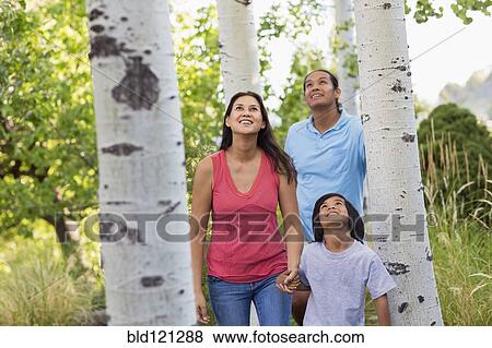 Family walking together outdoors View Large Photo Image Stock Photo - Family walking together outdoors. Fotosearch