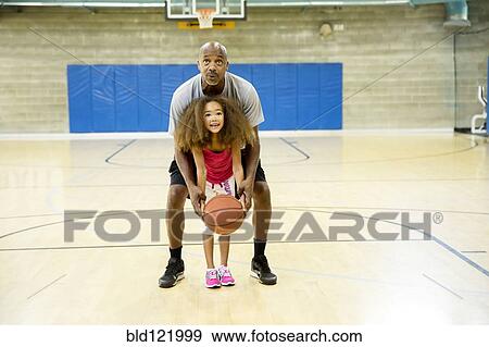 Father and daughter playing on basketball court View Large Photo Image Stock Photo - Father and daughter playing on basketball court. Fotosearch