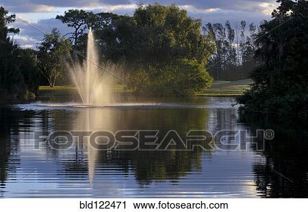 Fountain splashing in still lake View Large Photo Image Stock Image - Fountain splashing in still lake. Fotosearch