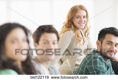Friends relaxing together on sofa View Large Photo Image Stock Photo - Friends relaxing together on sofa. Fotosearch