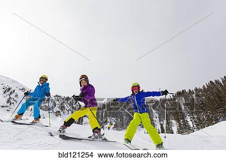 Picture - Girls skiing together on snowy slope. Fotosearch