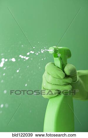 Green rubber glove squiring spray bottle View Large Photo Image Stock Photo - Green rubber glove squiring spray bottle. Fotosearch