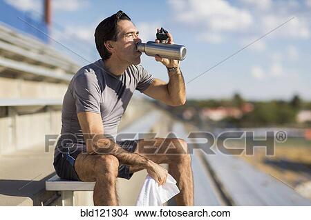 Hispanic athlete resting on bleachers View Large Photo Image Picture - Hispanic athlete resting on bleachers. Fotosearch