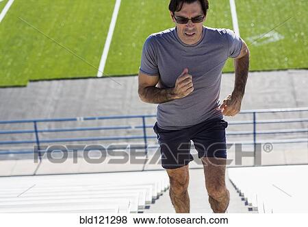 Hispanic athlete running on bleacher steps View Large Photo Image Stock Photo - Hispanic athlete running on bleacher steps. Fotosearch