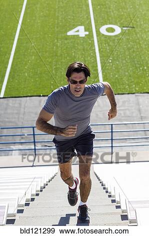 Hispanic athlete running on bleacher steps View Large Photo Image Stock Photo - Hispanic athlete running on bleacher steps. Fotosearch