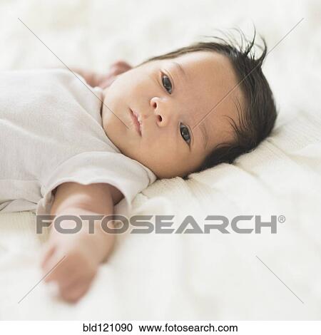 Hispanic baby laying on cot View Large Photo Image Stock Image - Hispanic baby laying on cot. Fotosearch