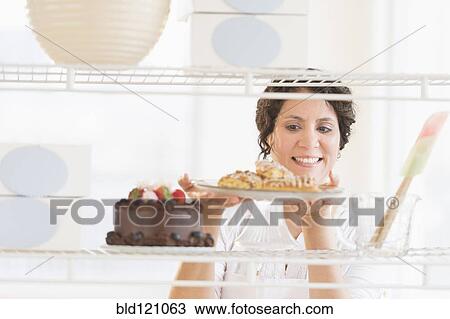 Hispanic baker holding fresh desserts View Large Photo Image Stock Image - Hispanic baker holding fresh desserts. Fotosearch