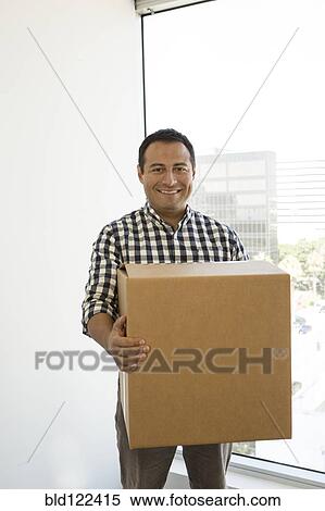 Hispanic businessman carrying cardboard box in office View Large Photo Image Stock Photography - Hispanic businessman carrying cardboard box in office. Fotosearch