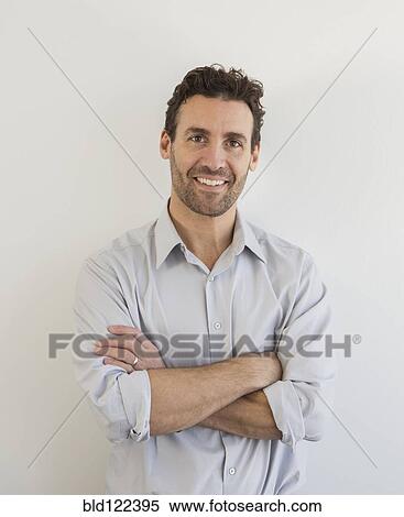 Stock Photography - Hispanic businessman smiling. Fotosearch