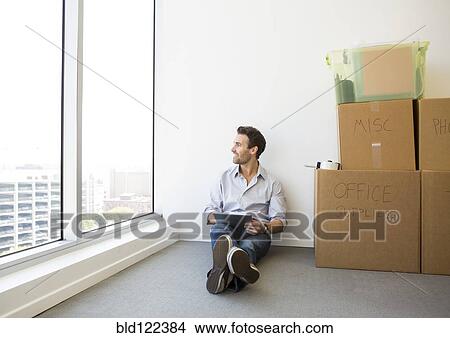 Hispanic businessman using digital tablet in new office View Large Photo Image Picture - Hispanic businessman using digital tablet in new office. Fotosearch