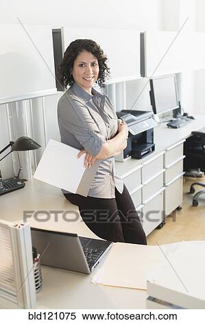 Stock Photography - Hispanic businesswoman smiling in office. Fotosearch